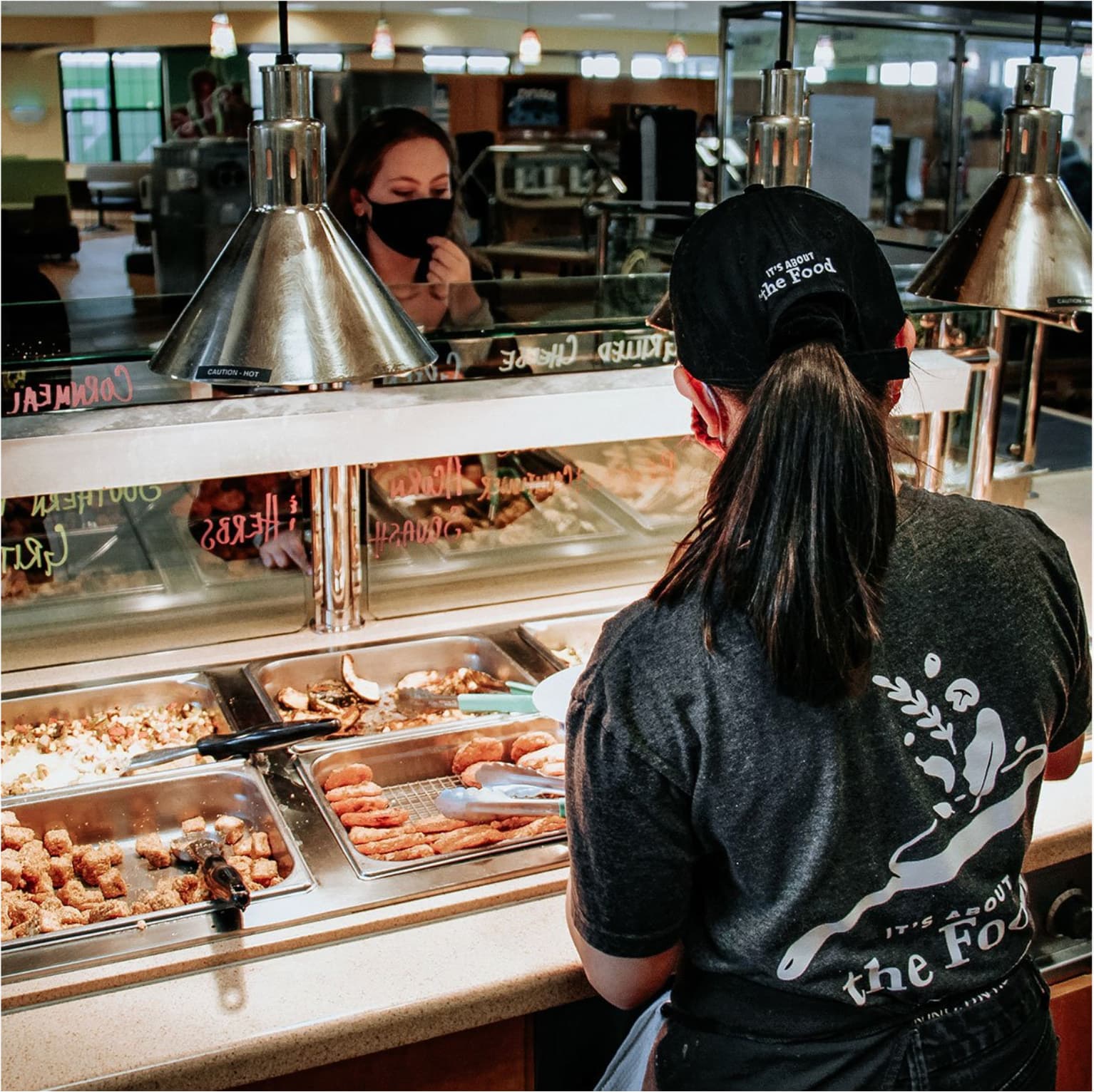 Part-time employee serving a student at Avenue A in Eagle Landing.
